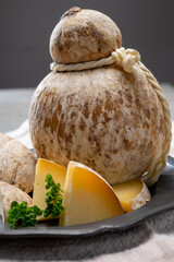 Italian semi hard matured caciocavallo cheese, handmade and aged in natural underground caves in...