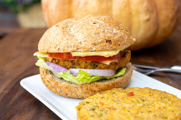 Making fresh and healthy vegetarian hamburgers with grilled pumpkin burgers, organic buns and vegetables