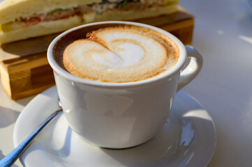 Breakfast coffee, Italian classic cappuccino with milk foam served in cafe