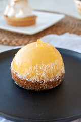 Small yellow  lemon ball tart from French pastry shop