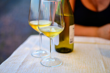 Two glasses of cold dry white wine served outdoor in cafe at night in Italy