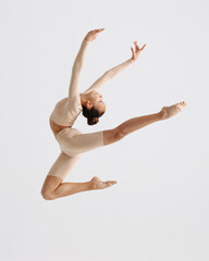 Young gymnast girl stretching and training