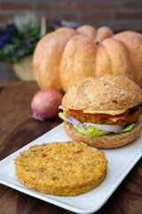 Making fresh and healthy vegetarian hamburgers with grilled pumpkin burgers, organic buns and vegetables