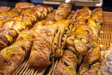 Assortment of french fresh baked sweet puff pastry in confectionery shop