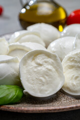 Tasty italian food, fresh white buffalo mozzarella soft cheese balls from Campania, tomatoes, fresh basil and olive oil