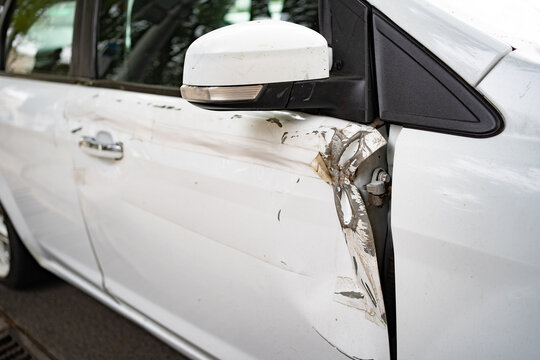 white car after an accident. broken, crumpled the door of the transport. insurance against accidents.