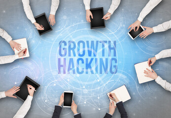 Group of people in front of a laptop with GROWTH HACKING insciption, web security concept