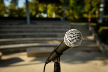 Microphone Stand in Empty Amphitheater with No People Outside at Sunset for Comedy Show or Live Entertainment