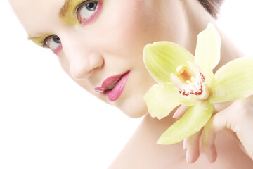 young woman with bright make up holding orchid