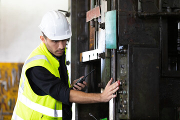 engineer man or worker pushing button on machine and controlling production
