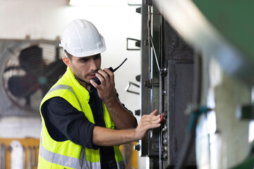 engineer man or worker pushing button on machine and controlling production