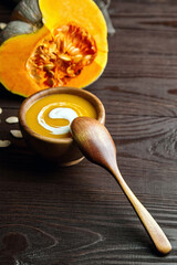 Homemade pumpkin soup with cream in bowl