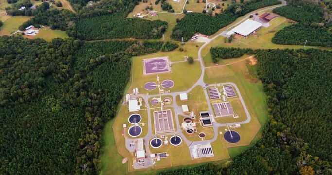 Wastewater Treatment Plant Next to Creek.  Overflight of a wastewater treatment plant in Graham, NC. The sewage treatment plant is bordered by the Big Alamance Creek and the Haw River is seen at the e