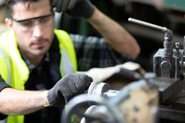 close up engineer man or factory worker feeling tired for working on the machine in...