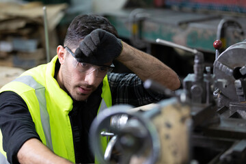 engineer man or factory worker feeling tired for working on the machine in factory