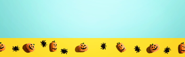Miniature Halloween pumpkin ghosts with spiders - flat lay