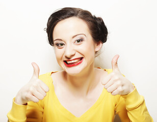 young girl gives thumb up with two hands