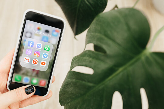 Hands of a woman use Iphone SE 2020 with social media