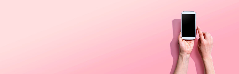 Person using a white smartphone from above