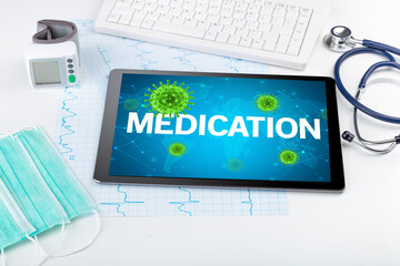 Close-up view of a tablet pc with MEDICATION inscription, microbiology concept