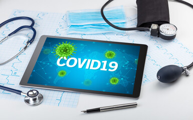 Close-up view of a tablet pc with COVID19 inscription, microbiology concept