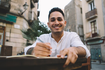 Delighted ethnic male looking at camera