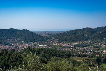 Fototapeta na wymiar Italian landscape view from Montecastrese, Camaiore to Viareggio, with mountains blue sky and sea