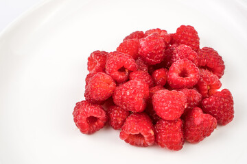 Fresh, juicy raspberries with water drops close-up. Berry background. The concept of proper nutrition