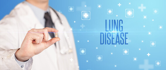 Close-up of a doctor giving a pill with LUNG DISEASE inscription, medical concept