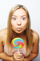 beautiful young woman with big colorful lollipop