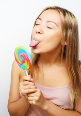 beautiful young woman with big colorful lollipop