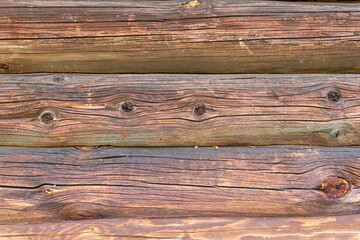 Ancient log walls of houses destroyed by time and decay