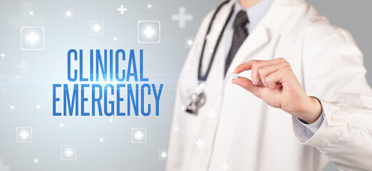 Close-up of a doctor giving a pill with CLINICAL EMERGENCY inscription, medical concept