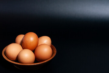 Chicken eggs in a Cup in the lower left corner of the frame.
