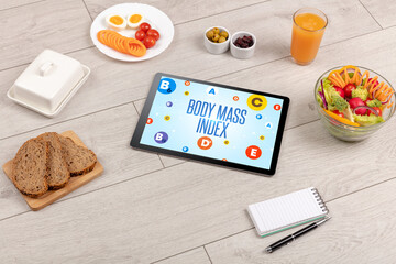 Healthy Tablet Pc compostion with BODY MASS INDEX inscription, weight loss concept