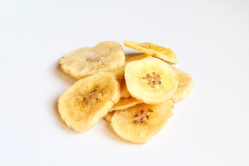 Pile of dry banana slices isolated on white background. Dried fruit chips
