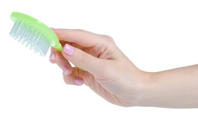 Green baby hair brush comb in hand on white background isolation