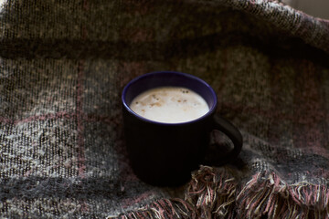 Black coffee cup,pale grey scarf. Autumn background