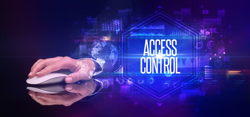 hand holding wireless peripheral with ACCESS CONTROL inscription, cyber security concept
