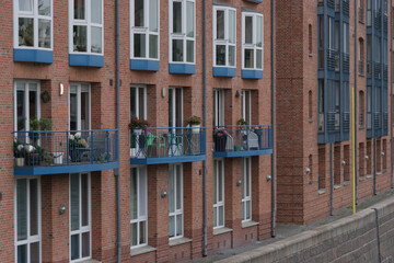 Old historic brick building with small balconies at the riverside