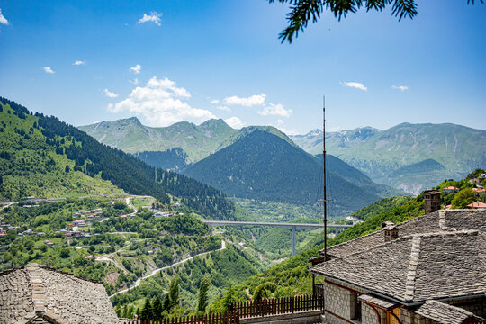 Spring landscape high angle view, roofs and valley from town of Metsovo, Epirus, Greece. The establishment is popular winter ski Greek resort with old Balkans style houses