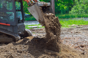 Bulldozer moving, leveling ground at construction site