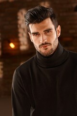 Obraz premium Portrait of handsome young man with trendy hair style, looking at camera.