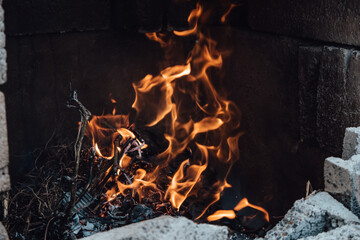 Tongues of flame burning in stone furnace close up.