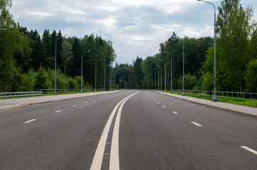 New four-lane highway with a forest background.
