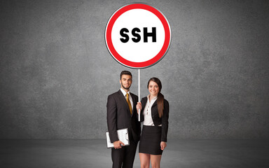 Young business person holdig traffic sign with SSH abbreviation, technology solution concept