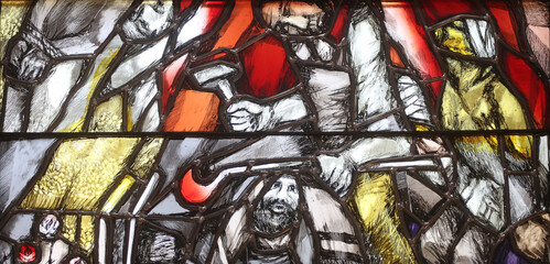 God bears the guilt of all mankind, takes hold of sinners and saves them from death, detail of stained glass window by Sieger Koder in St. John church in Piflas, Germany - obrazy, fototapety, plakaty