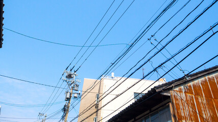 Blue sky and Japanese utility poles and wires