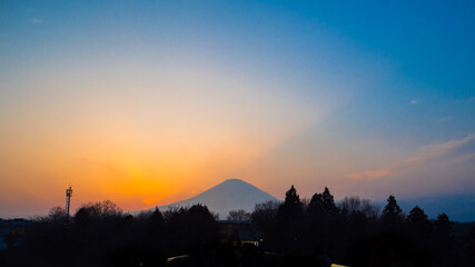 Japan at sunset Mount Fuji on the background of the red sunset Japanese evening scenery Mount Fuji silhouette on the sky background Autumn of Japan.