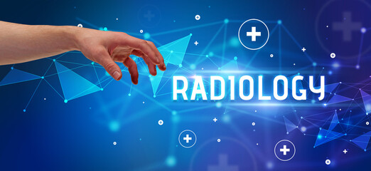 Close-Up of cropped hand pointing at RADIOLOGY inscription, medical concept